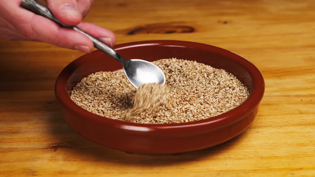 White dried sesame seeds close-up macro. Super food. Sprinkles for food.Healthy concept. High quality 4k footage