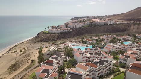 aerial panoramic shot of fuertevenrura coastline with hotel and luxury resort