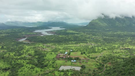 flying from the mountains to the backwaters of the river in the western ghats as the monsoon clouds flow by