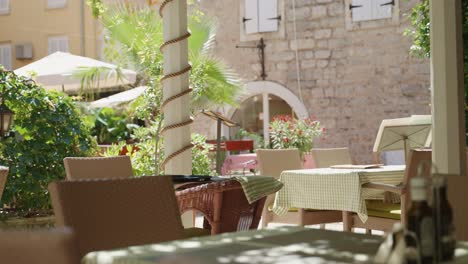 small restaurant patio with tables and chairs serving local food in town center