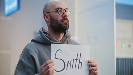 man holding a name tag