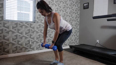 mujer hispana haciendo ejercicio en casa, ejercicio con mancuernas en la habitación