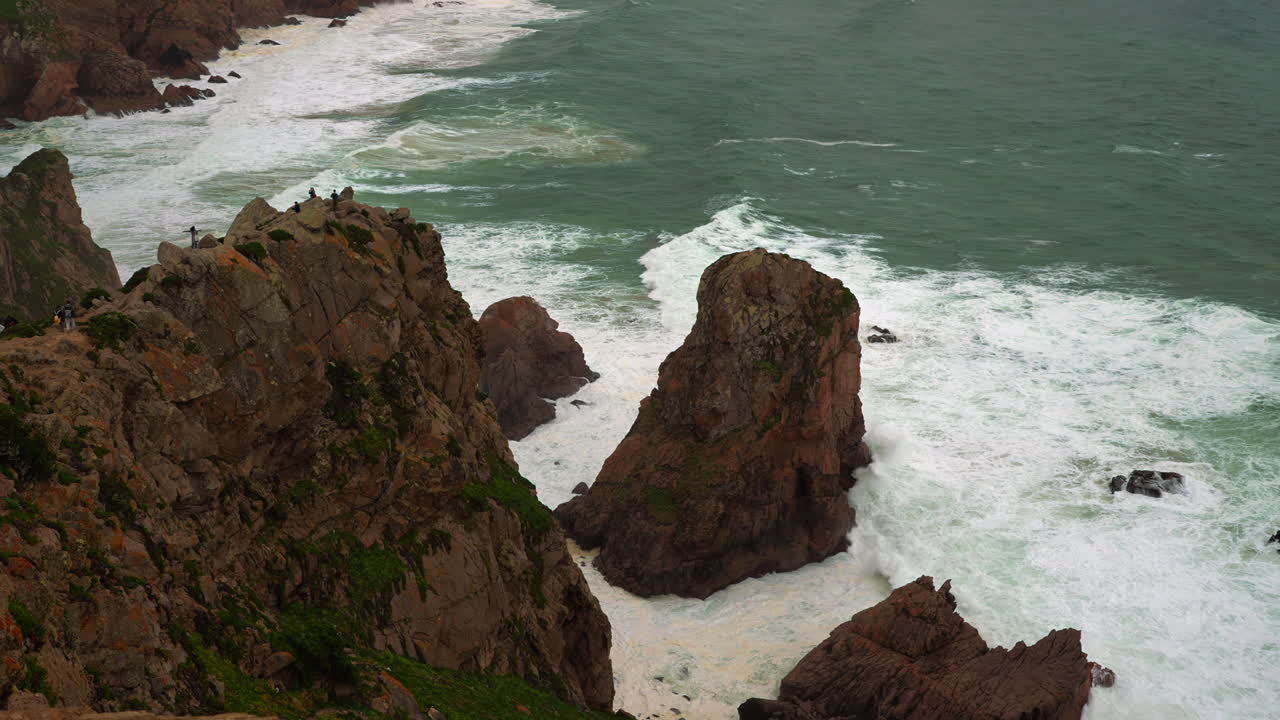 Coastal Rocky Cliffs with Waves and People