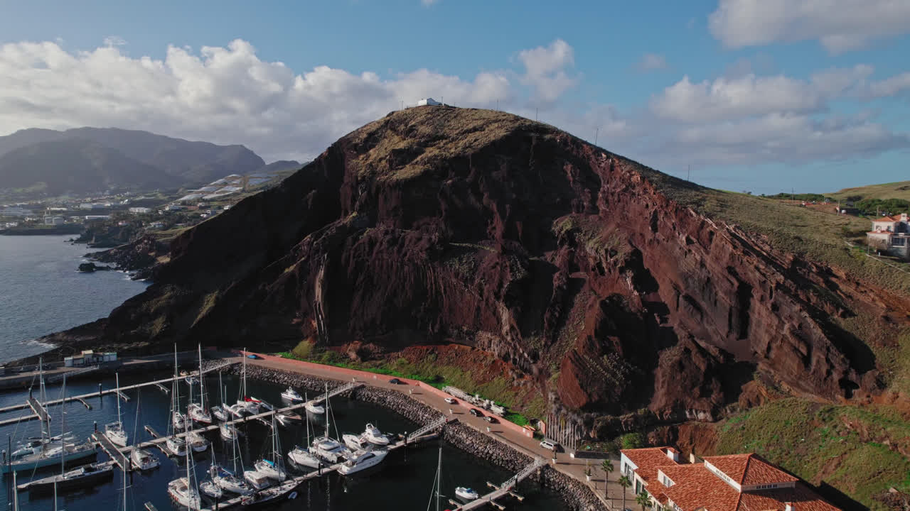 Aerial view of a marina and volcanic mountain