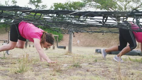 Female-friends-enjoying-exercising-at-boot-camp-together