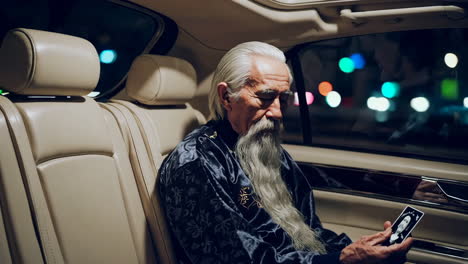 elderly man in a car at night