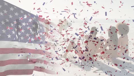 American-flag-waving-and-confetti-falling-against-group-of-friends-having-fun-at-the-beach