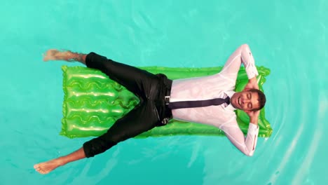 un hombre de negocios húmedo relajándose en un inflable.