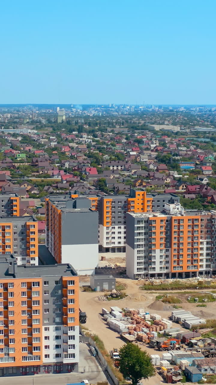 Modern architecture in the city. High rise buildings. Multi-storey buildings built in rural area near the river. View from above. Vertical video