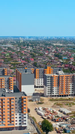 modern architecture in the city. high rise buildings. multi-storey buildings built in rural area near the river. view from above. vertical video