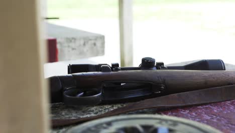 closeup of a wooden rifle on the table at the firing range