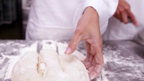 Pastry-chefs-preparing-dough-at-counter