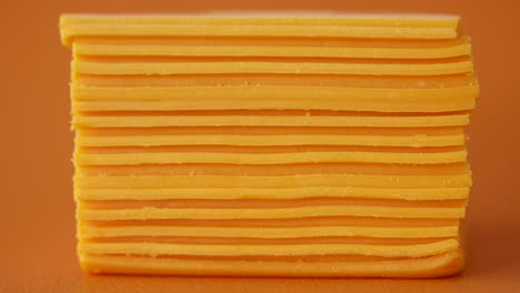 close-up of a stack of cheddar cheese slices