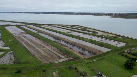 evaporation on salt marshes in the île de ré island western france at village of loix, aerial orbit left shot