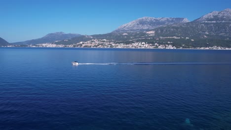 Aerial-View,-Rose-Village,-Boat-in-Kotor-Bay-and-Herceg-Novi-Town,-Waterfront-Buildings-on-Sunny-Summer-Day,-Montenegro