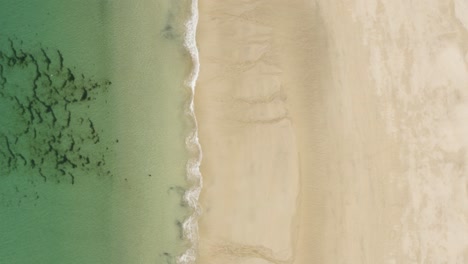 vertical shot of idyllic beach with relaxing waves at st ives in cornwall, england, uk