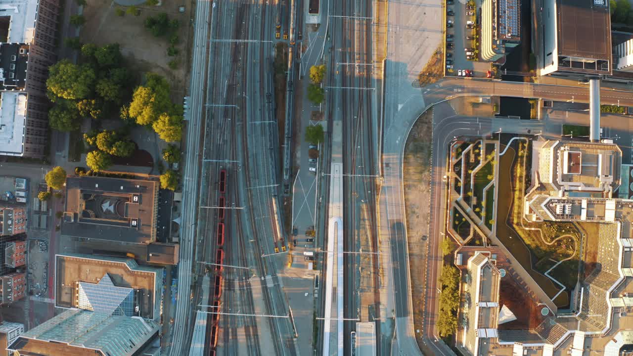 Deserted train tracks, streets and roads around central train station of Utrecht city during lockdown for containment of Corona virus, Netherlands. Aerial view top down drone view