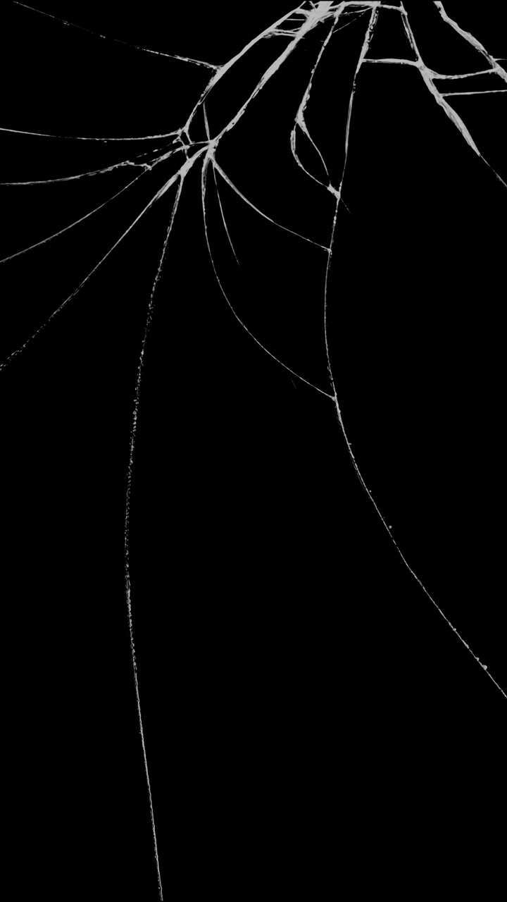 Fine, delicate cracks spiderweb from the top corner of a glass surface. A subtle vertical overlay for representing minor damage or a distressed aesthetic