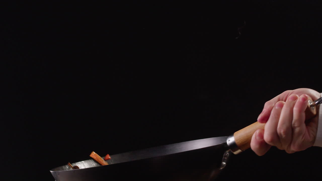 Chef Stir-Frying Vegetables in a Wok