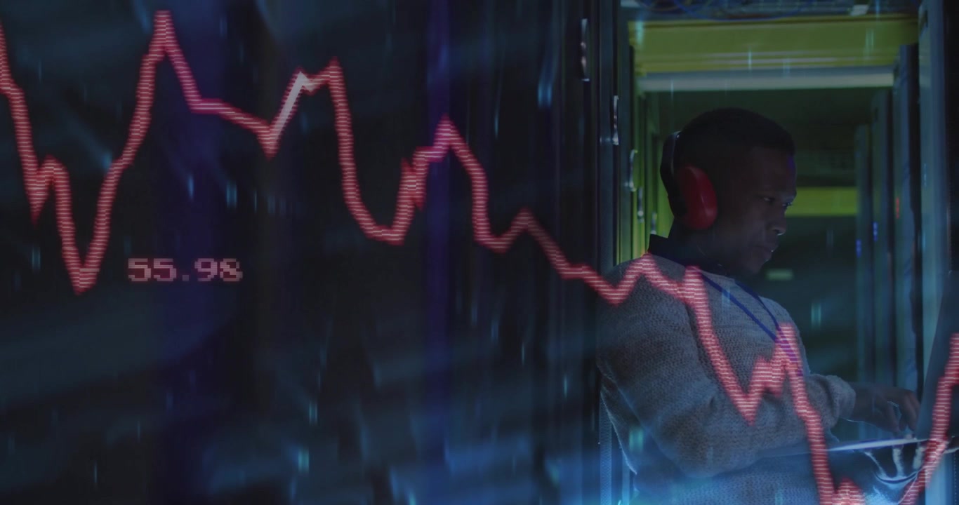 Data analyst tapping tablet while inspecting data with translucent red chart over server racks