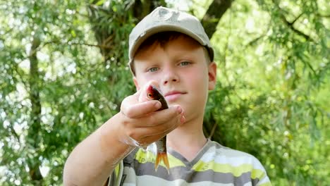 boy holding a fish