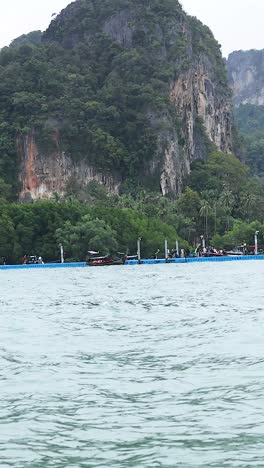 tropical island pier with mountains and boats