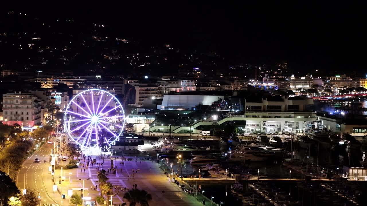 Aerial drone view of Promenade de la Pantiero street in Cannes, France at night