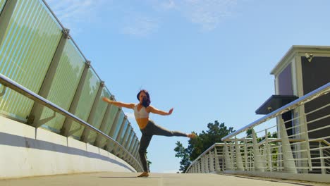 young female dancer dancing on a bridge in the city 4k