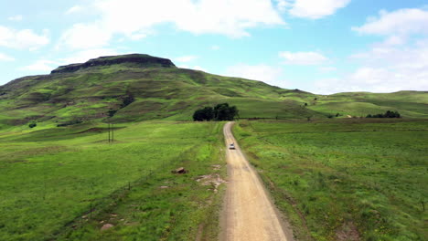 4k drone footage of a car travelling along a rural