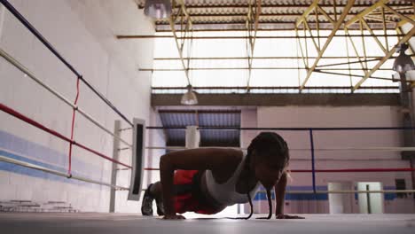 mixed race woman working out in boxing gym