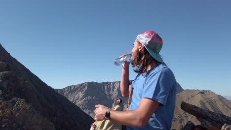 Hiker-drinking-water-watching-resting-circled-Kananaskis-Alberta-Canada