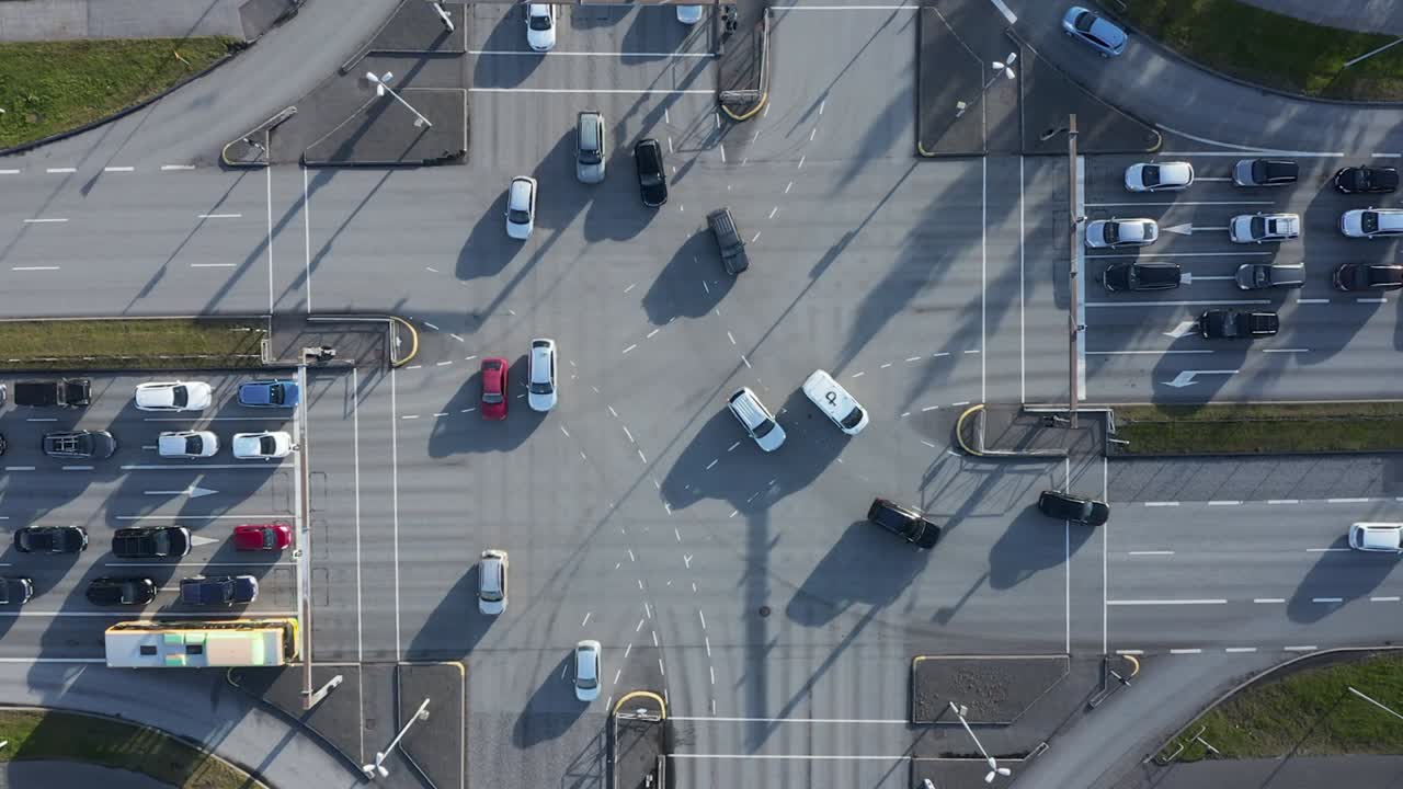 Coches circulando por la intersección en un día soleado, vista aérea
