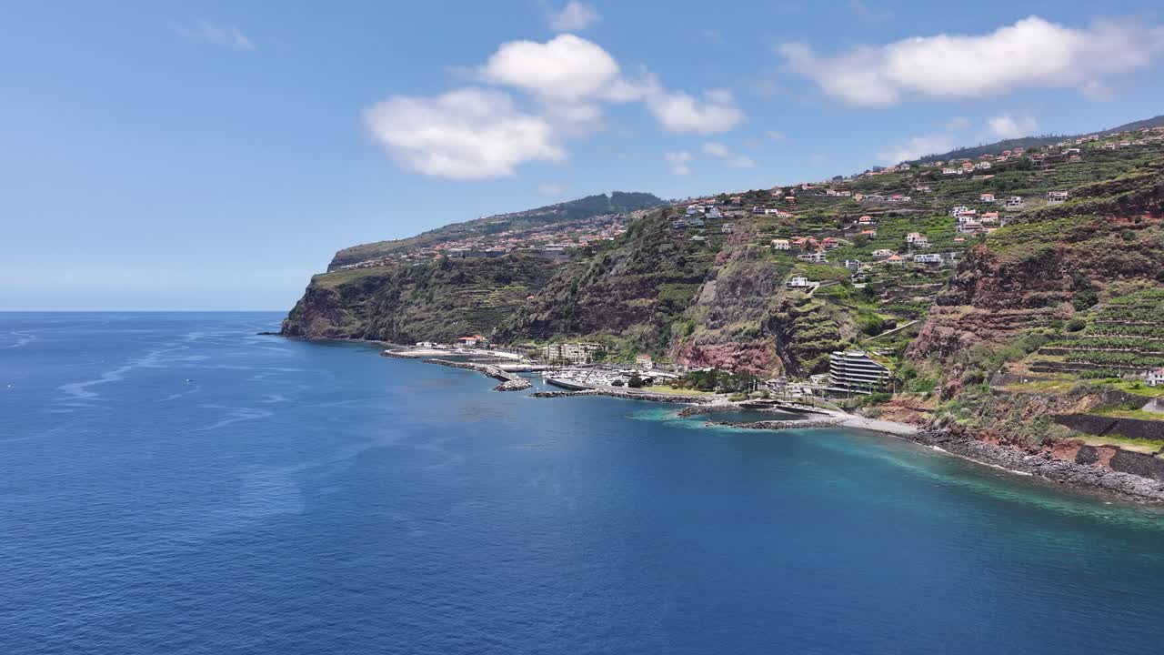 Aerial approach toward dramatic steep coastline of Calheta, Madeira, Portugal