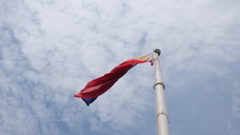 flag blown by the wind to the left as the camera moves forward, philippine national flag