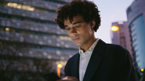 worried businessman reading telephone dusk street closeup. man feeling stressed