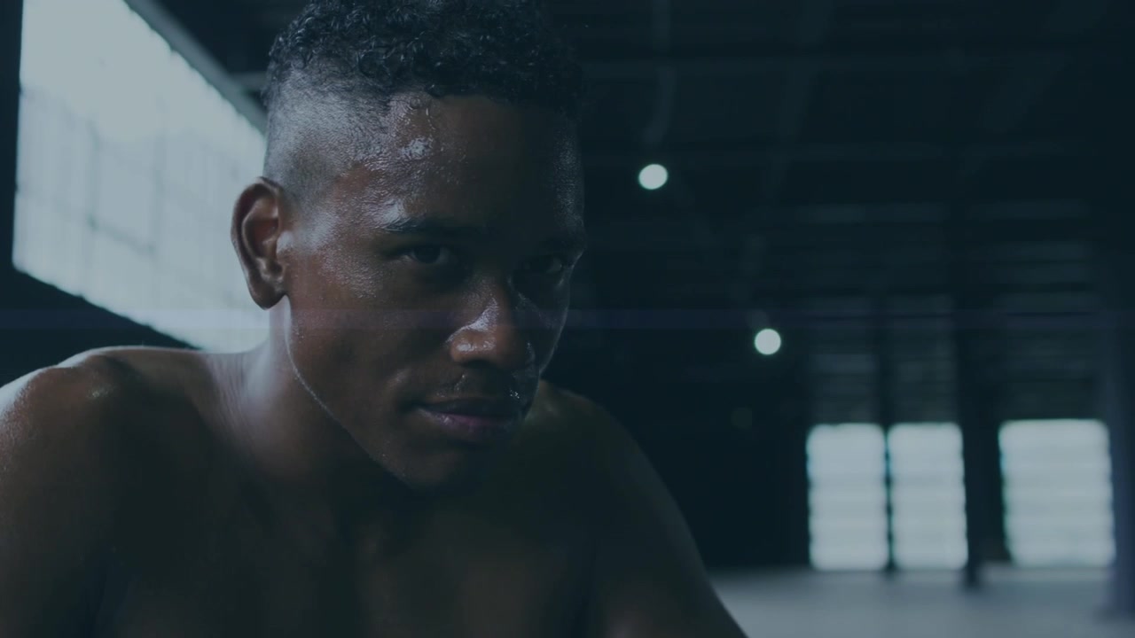 Sweaty Athlete Resting After Intense Workout in Industrial Gym