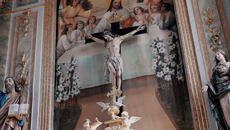 ornate church altar with crucifix and frescoes