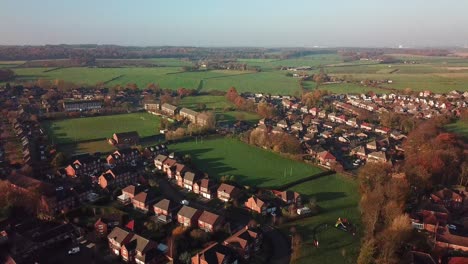 Ascending-shot-over-British-small-town-on-edge-of-countryside