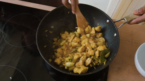 cooking chicken curry in a wok