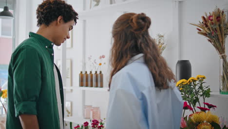 beautiful couple buy flowers on date. young girlfriend boyfriend choose bouquet.