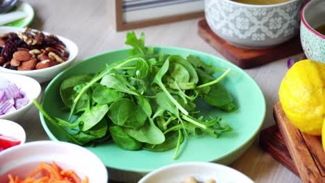 adding spinach leaf salad plate nuts almonds lemons pumpkin seeds tomatoes leaf spinach dressing