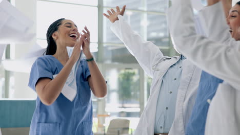 high five, paper throw and applause by doctors