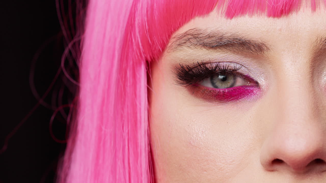 Macro shot of positive confident lady blinking on camera