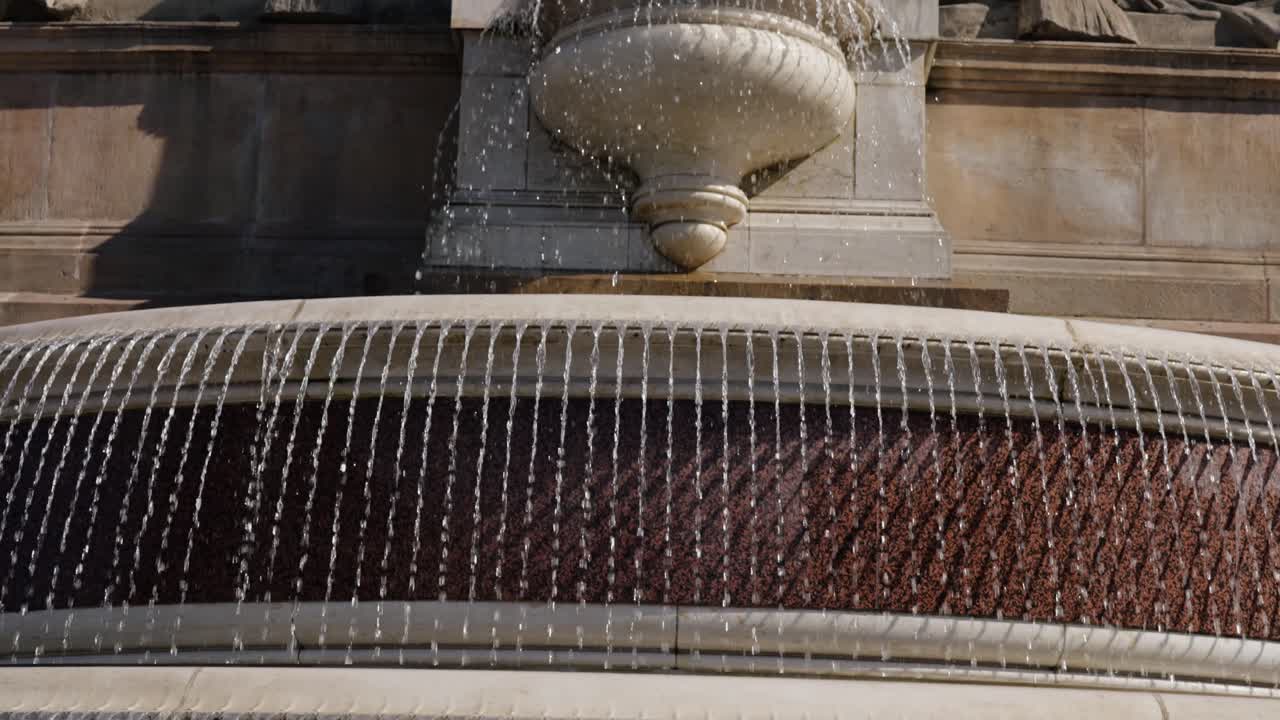 Close-up view of a fountain with streams of water falling in parallel lines