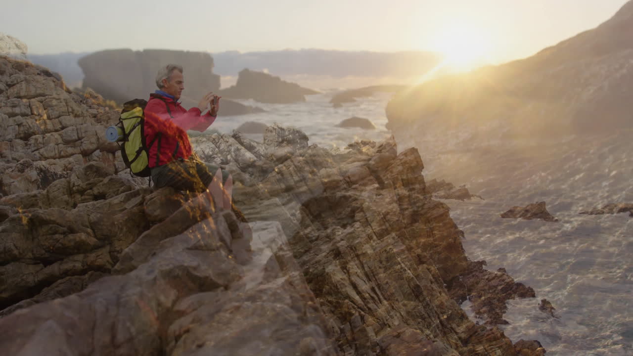 Hiker using smartphone on rocky coast, generating animated map pin and wave chart for travel tech
