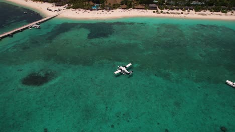 Seaplane-parking-near-jetty-on-calm-blue-waters-of-crystal-clear-indian-ocean-in-maldives-Kuredu-island-resort