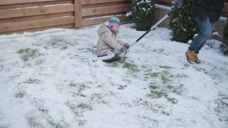 grandfather and granddaughter having fun in the snow