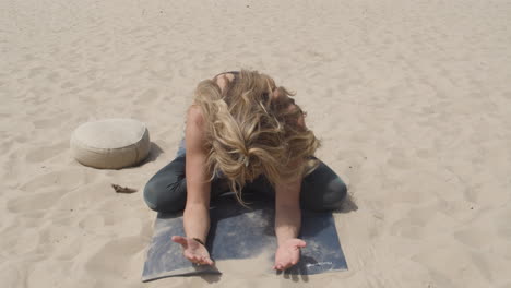 beautiful woman practicing yoga and bending forward