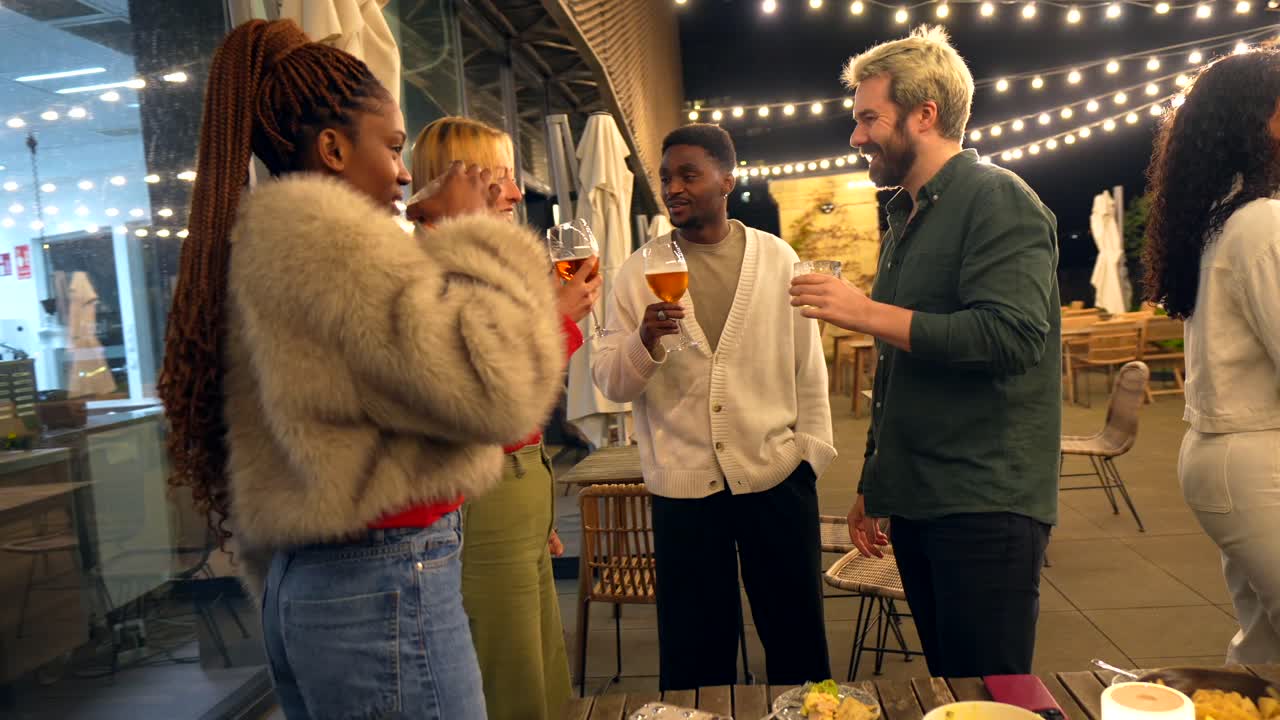 People Enjoying an Outdoor Gathering with Food and Drinks