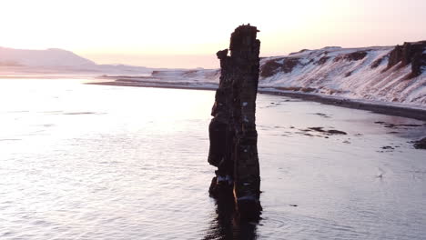 Hvitserkur is a lonely cliff on the shore far in Iceland's north. It reminds prehistoric animal turned into stone